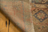 Hand-knotted foundation, secured selvage, and distressed low pile of a vintage Oushak rug.