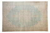 Distressed vintage Sivas carpet with an oversize faded blue medallion and scrolling vinery.