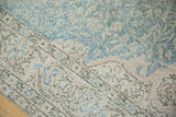 Distressed vintage Sivas carpet with worn pile showing foundation, sky blue and beige vinery.