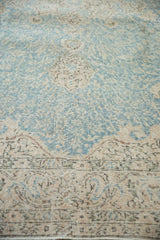 Vintage Sivas carpet: Distressed sky blue and beige scrolling vinery with visible worn knot heads.