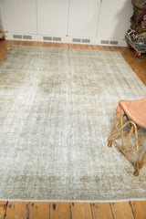 Distressed vintage Kashan carpet corner, showing subtle worn design and even textured pile.