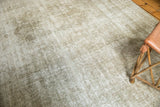 Distressed texture of vintage Kashan rug showing ivory, sand, and dusty bronze tones.
