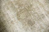 Distressed Kashan carpet's textured pile with visible knot heads in ivory and dusty sand.