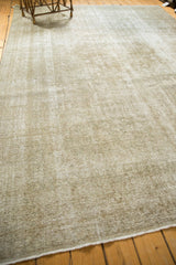 Distressed texture and mostly even wear on the ivory, sand hues of a vintage Kashan rug's side.