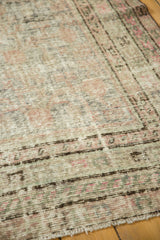 Vintage distressed Khotan rug with mostly even wear, muted apricot, celadon green, and charcoal tones.