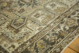 Distressed vintage Heriz carpet, geometric motifs, worn pile, coffee brown, ivory, and saffron hues.