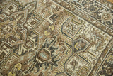 Distressed texture and geometric Heriz pattern in coffee brown, ivory, and dusty saffron tones.