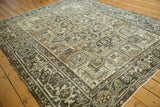 Distressed vintage Heriz carpet showing geometric field motifs and classic turtle border.