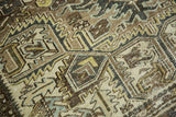 Distressed vintage Heriz carpet texture, geometric pattern in coffee brown, gray, and ivory, showing wear.