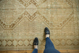 Faded sand and brown geometric pattern on vintage Afshar carpet, with feet.