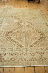 Distressed Afshar rug border, featuring geometric motifs, soft fringe, and even wear.