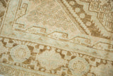 Distressed sand, faded coffee brown, and light blue geometric details on vintage Afshar carpet.