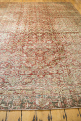 Distressed vintage Heriz rug texture with mostly even wear and faded Herati motif.