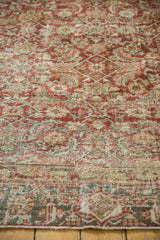 Distressed pile texture with madder red and seafoam Herati motifs on vintage Heriz carpet.