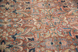 Vintage Heriz carpet's expressive floral motifs, mostly even wear on brick red and navy.