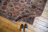Distressed vintage Veramin carpet with copper, burgundy hues and soft, worn pile.