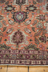 Distressed texture of a vintage Veramin carpet showing repeating copper, burgundy, and slate blue columns.