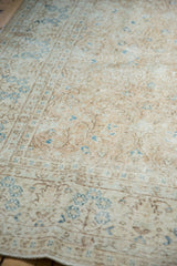 Distressed Sparta rug texture, showing worn pile, faint foundation, ivory, and blue vinery.