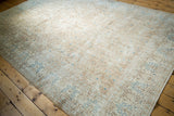 Distressed Sparta carpet corner, ivory field with pale coffee vinery and sky blue blossoms.
