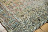 Distressed vintage Afshar rug corner, geometric floral design in dusty rose and slate blue.