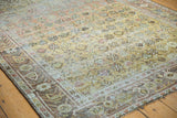 Vintage Afshar rug corner with distressed pile, faded geometric motifs, and antique ivory border.