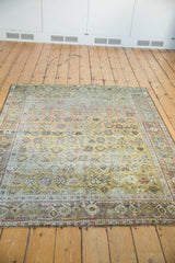 Textured pile of the distressed vintage Afshar rug, highlighting floral-geometric patterns and muted hues.