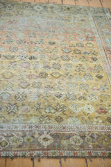 Distressed texture and geometric patterns at the vintage Afshar rug's corner.