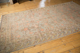 Distressed Khotan carpet end with pale grapefruit red pomegranate motif and even wear.
