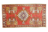 Cherry red Oushak rug, expressive purple medallion, germinating planter corners. 1'6