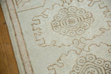 Distressed vintage Oushak rug's striped side cord, ivory low pile, and pale coffee brown motifs.