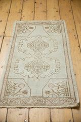 Vintage distressed Oushak rug corner, pale coffee brown floral spandrel on antique ivory.