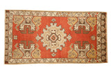 Vintage Oushak hand knotted runner with brick red field, central medallion, and germinating planters.
