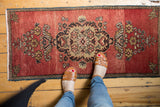 Vintage Oushak rug with Rococo floral medallion and abrashed brick red field.