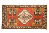 Vintage Oushak rug with brick red field, ivory stepped medallion, and saffron yellow corner planters.