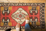 Vintage Turkish Oushak rug, stepped medallion, brick red field, saffron and ivory planter motifs.