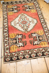 Saffron germinating planter motif on vintage Oushak rug's brick red field, intact selvage.