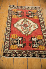 Vintage Oushak rug corner showing geometric germinating planter design on brick red field.