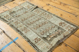 Vintage distressed Oushak rug mat with hard etched low pile and knot heads on its crab motif border.