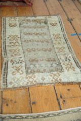Distressed vintage Oushak rug detail, showing low pile, textured field, and worn border.