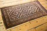Hand-knotted fringe and faded geometric border on this vintage Belouch rug runner corner.