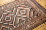 Geometric concentric medallion pattern in brown, navy, silver, and dusty rose.