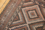 Hand-knotted geometric border and stepped motifs in dark chocolate, dusty rose, oxidized silver.