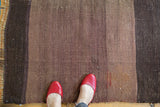 Handwoven vintage Turkish Kilim rug with horizontal striated mauve, eggplant, and charcoal bands.