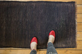 Dynamic charcoal wefted weave texture showing light foundation threads on a vintage Turkish Kilim rug.