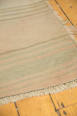 End detail of vintage Turkish Kilim runner, secure spun fringe and subtle striped weave.