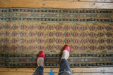 Vintage Malayer runner featuring repeating paisley botehs, dusty gold saffron field, and mostly even wear.