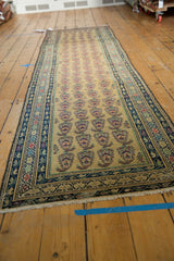Vintage Malayer runner's ivory fringe and dark blue border with repeating paisley botehs.