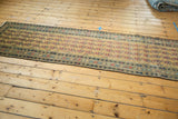 Elongated vintage Malayer runner showcasing repeating paisley botehs on a dusty gold field.