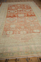 Low angle view along a distressed Khotan runner, highlighting the even wear and lovely color abrashes.
