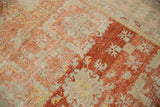 Angled view of the distressed texture and low pile on a vintage Khotan runner.